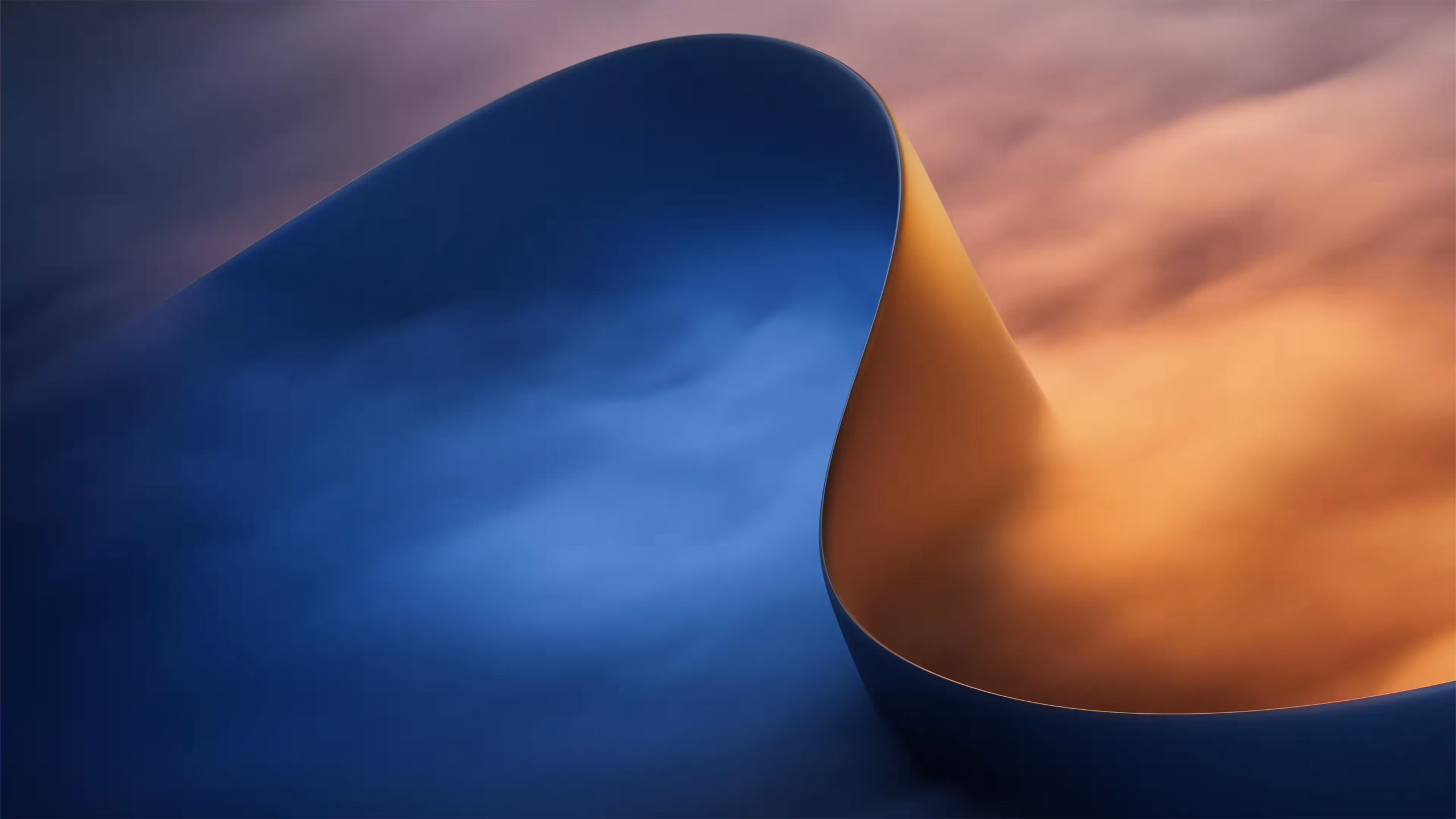 Creator Pro RTX Spark wallpaper with a deep blue curve folding into orange