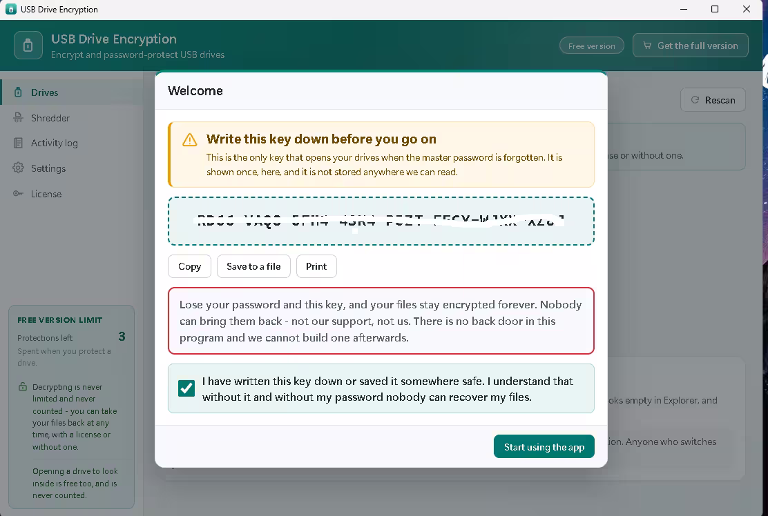 Recovery key screen with the key blurred out, copy, save and print buttons, and a warning that lost keys cannot be recovered